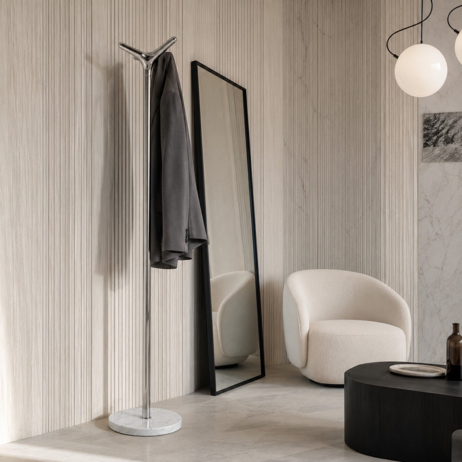 Addo Shop Leda Coat Stand with chrome pole and white marble base, holding a grey jacket.
