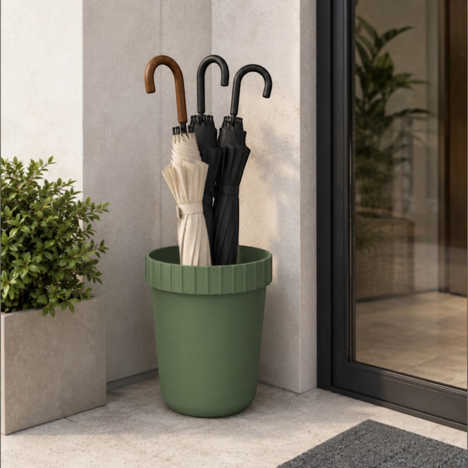 Addo Shop Raffles System green plastic umbrella stand with fluted rim holding beige and black umbrellas.
