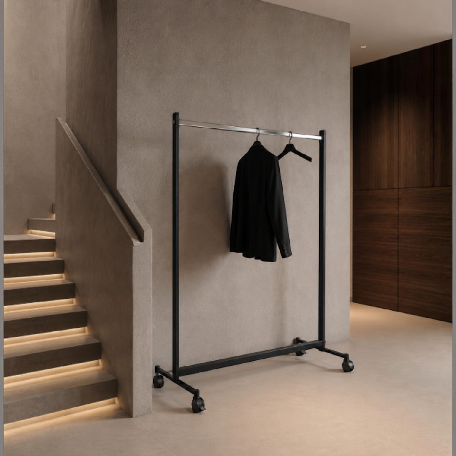 Addo Shop Rapid black metal coat rack with wheels, holding a black jacket.