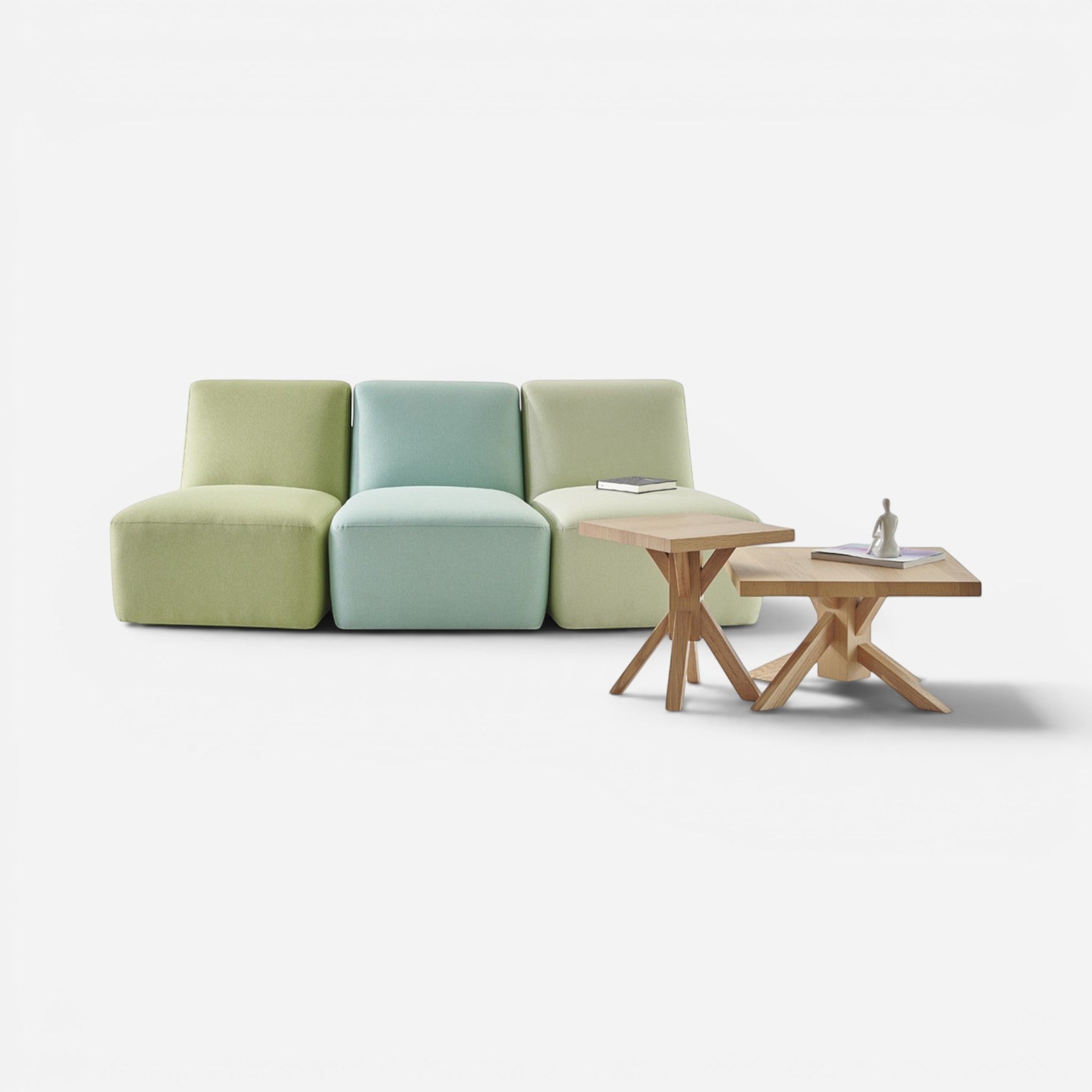 Addo Shop Talos modular sofa in light green, mint green, and pale green fabric with metal legs. Two wooden side tables.