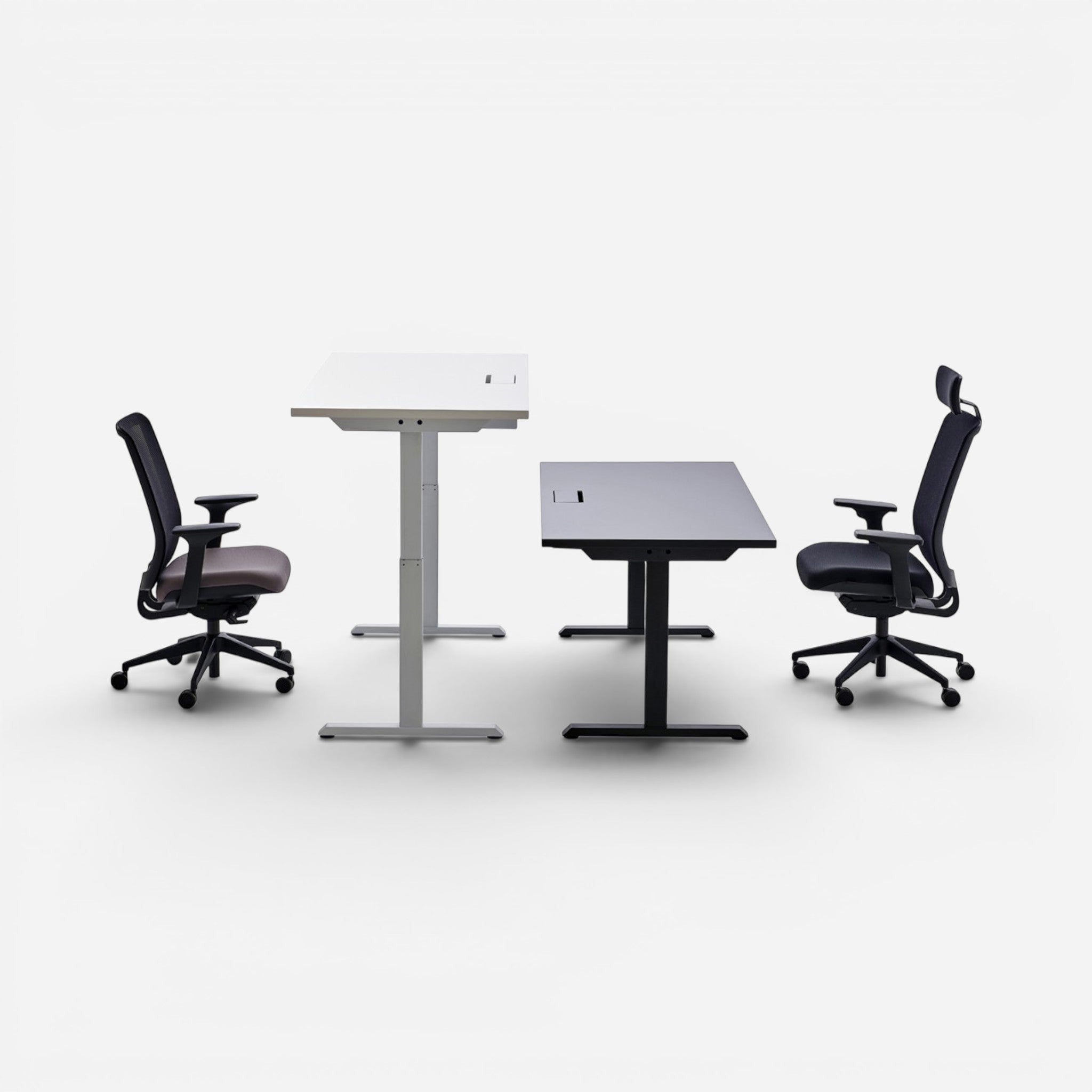 Addo Shop Up Down sit-stand desk with white laminate top and grey metal legs, and a black desk with black legs. Two office chairs shown.