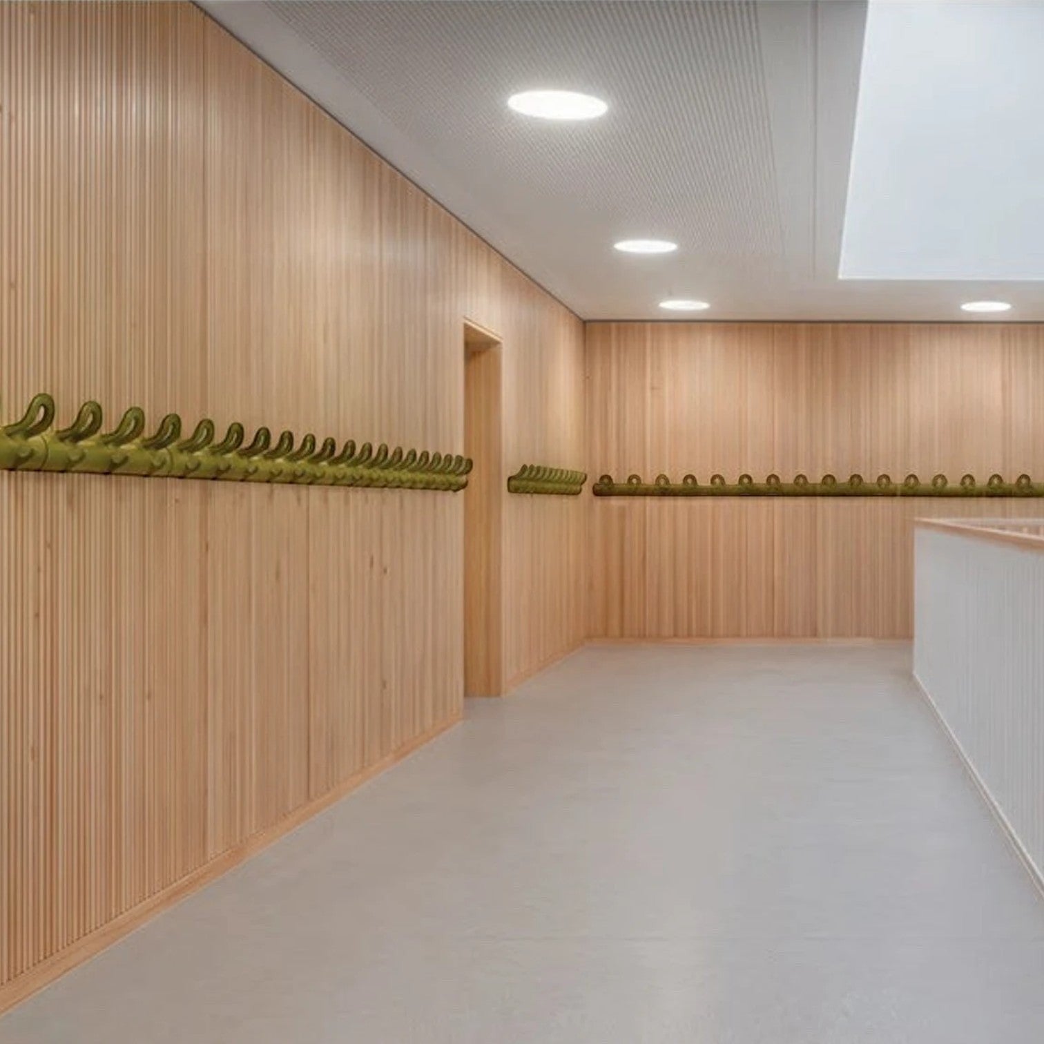 Addo Shop wall-mounted coat hooks in lime green, featuring a minimalist design with multiple curved hangers on a slatted wood wall.