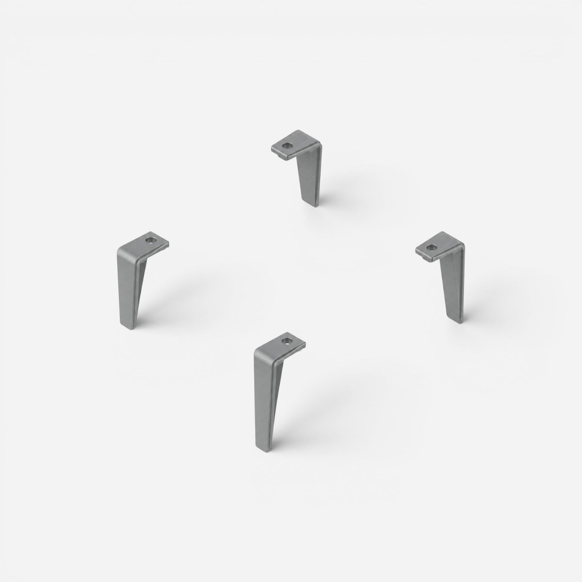 Caimi Desk-Up istifleme ayakları, metal gri renkte dört adet L formlu ayak, beyaz fonda üstten açılı görünüm